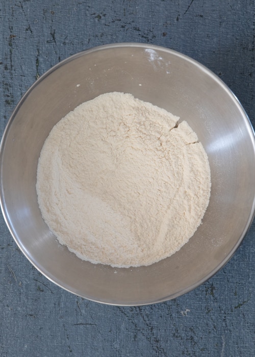 The dry ingredients whisked in a silver bowl.