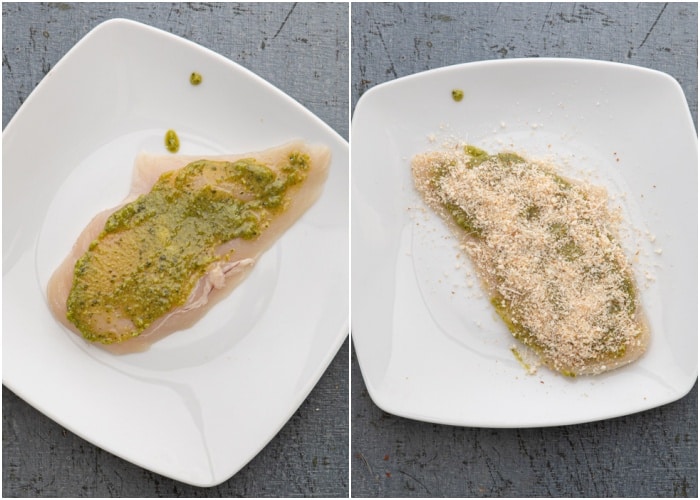 Spreading on the pesto and bread crumbs on the chicken.