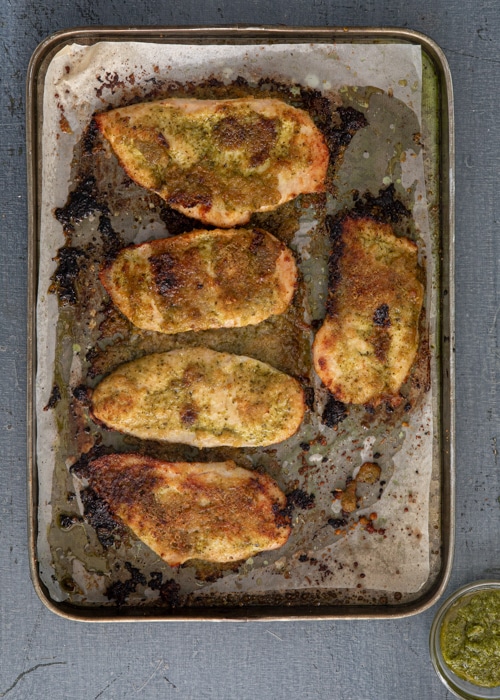 The baked chicken on the baking sheet.