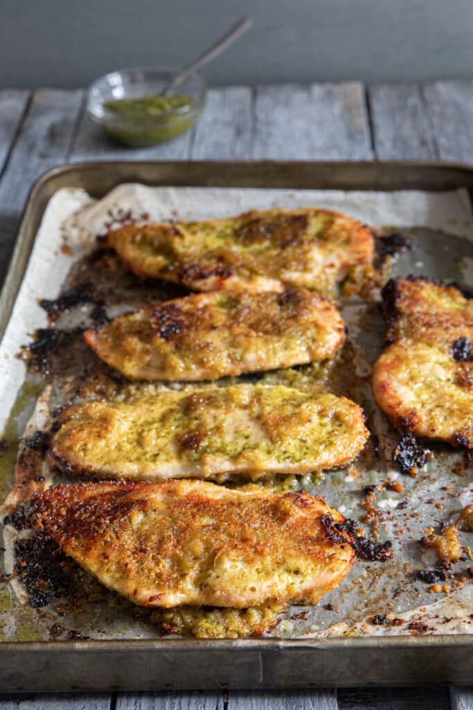 Baked chicken on baking sheet.