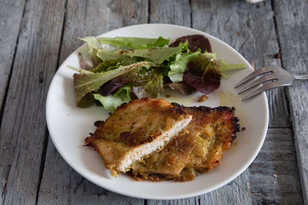 A slice of pesto chicken cut on a plate.