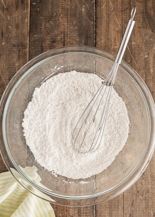 Whisking the dry ingredients in a glass bowl.