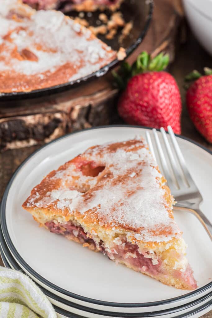 A piece of strawberry on a white plate.