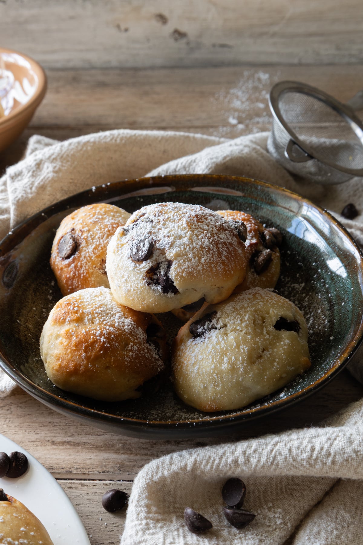 Ricotta cookies on a black plate.