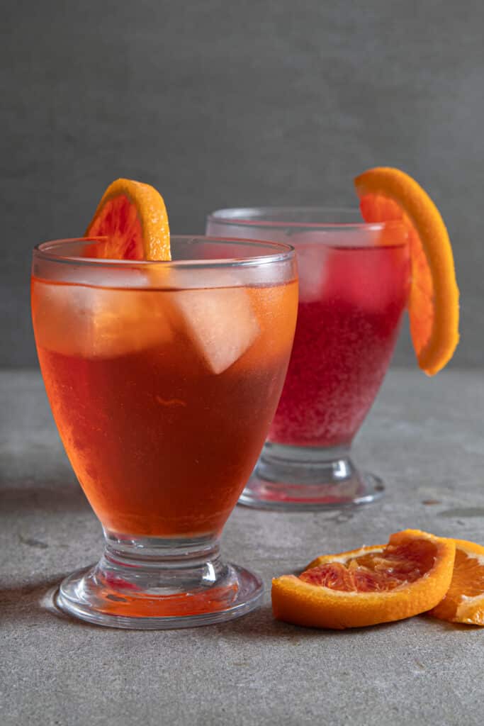 Aperol and Campari spritz on a grey board.