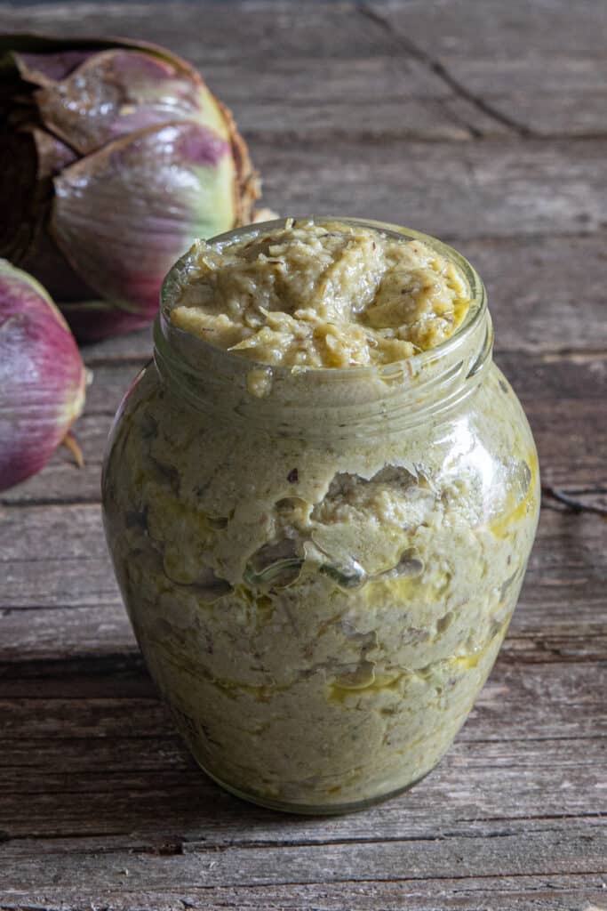 Artichoke pesto in a glass jar.