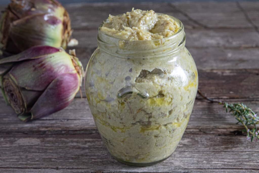 Artichoke pesto in a glass jar.