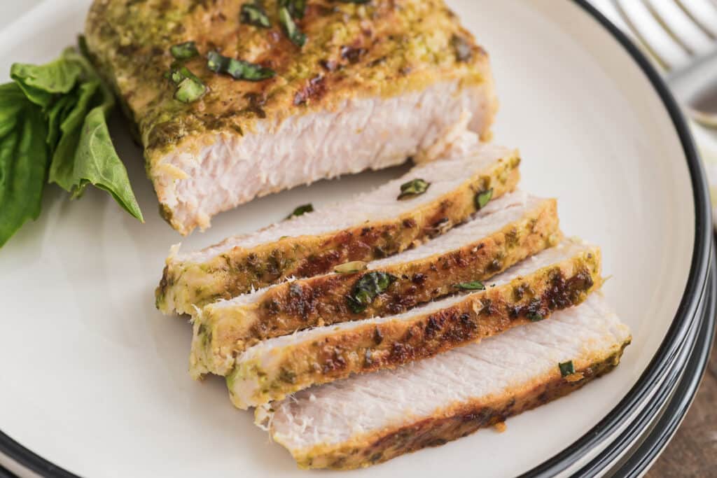 Pork on a plate with slices cut.
