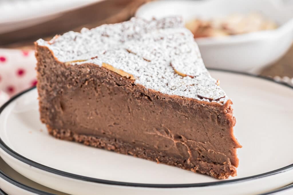 A slice of torta di nonno on a white plate.