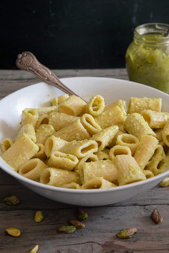 Pasta with pesto in a big bowl with a spoon.