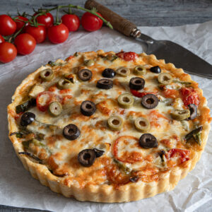 Savory vegetable pie on parchment paper.