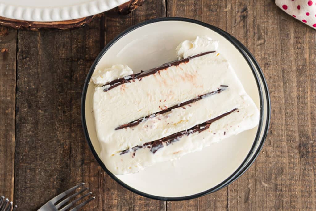 A slice of vienetta on a white plate.