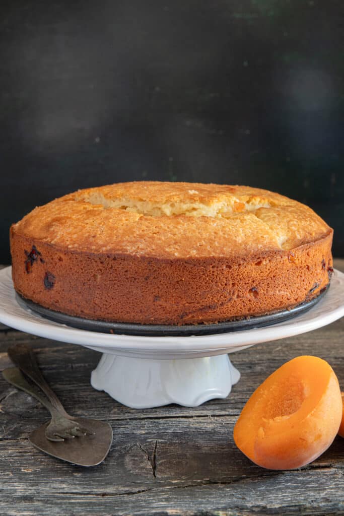 A cake on a white plate stand.