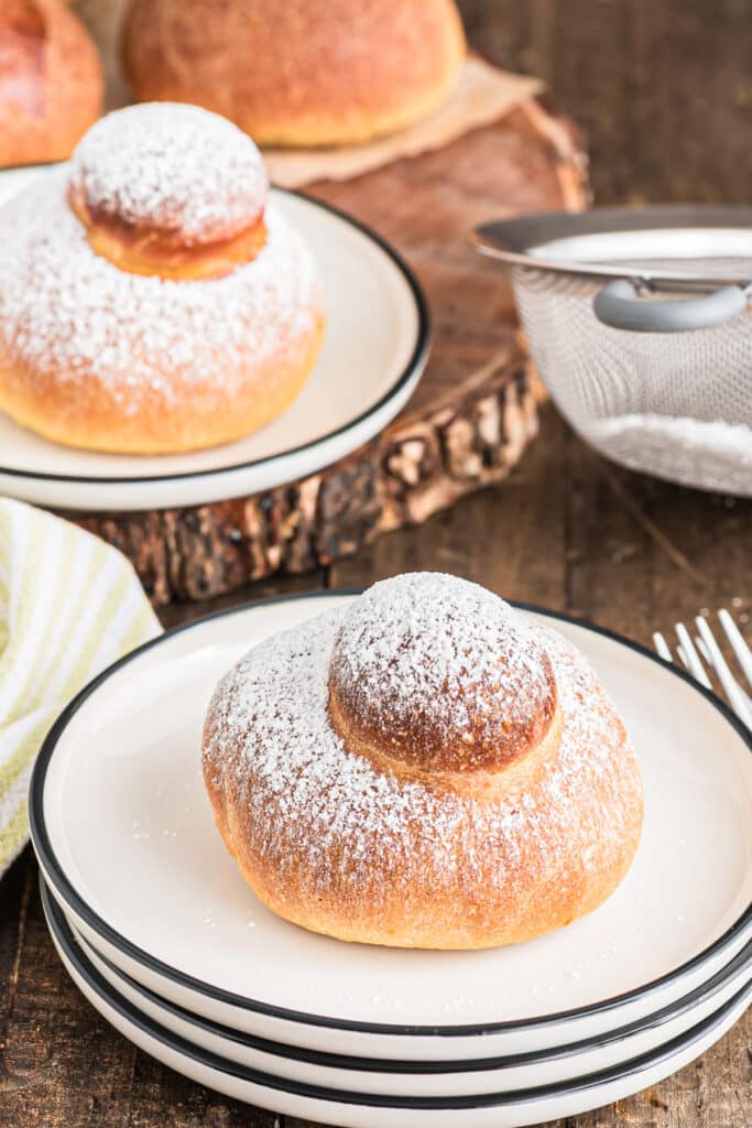 Brioche buns on a two white plates.