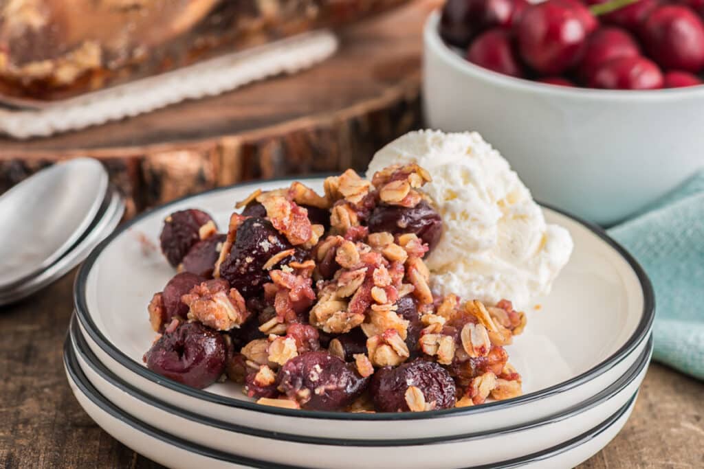 Cherry crumble and ice cream on a plate.