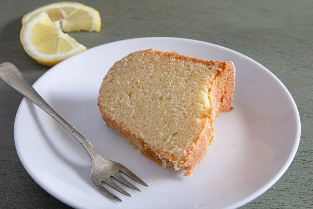 A slice of cake on a white plate.