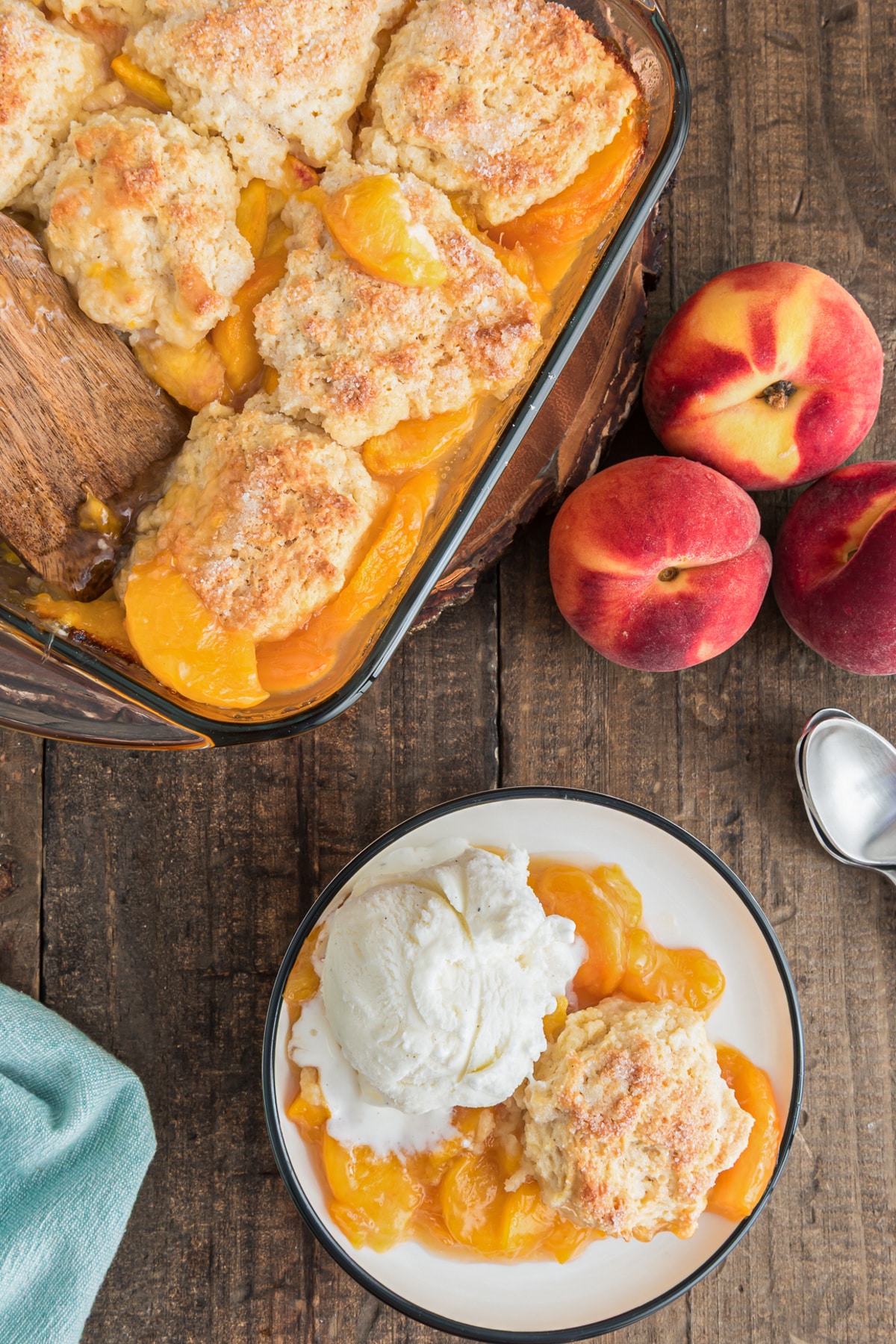 Peach cobbler in the pan and on a small white plate.