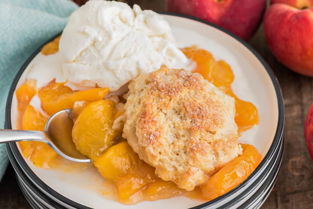 Peach cobbler on white plate.