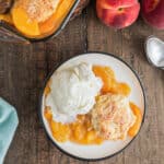 Peach cobbler on white plate.
