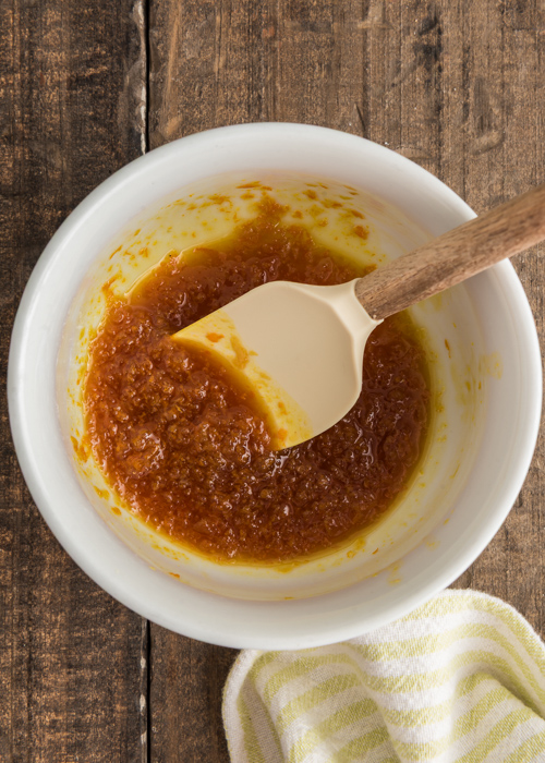 Making the lemon sugar mixture in a white bowl.