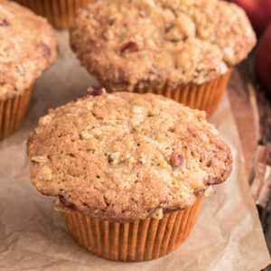 Peach muffins on brown paper.