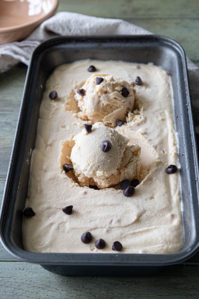 Two scoops of ice cream on the ice cream in the loaf pan.