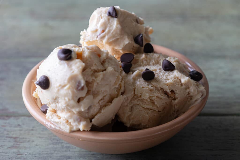 Three scoops of ice cream in a bowl.