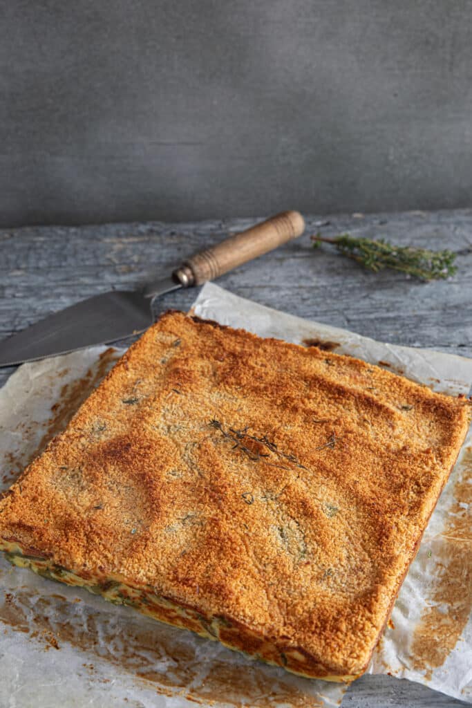 Genovese meatloaf on a piece of parchment paper.