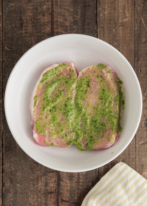 The sauce on top of the pork chops.
