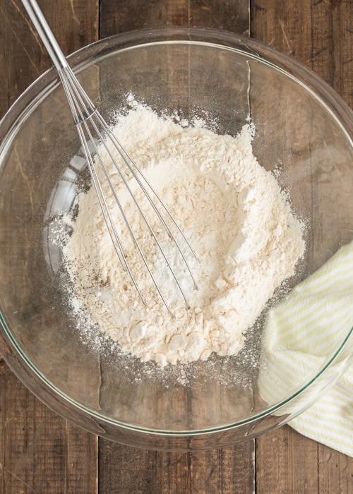 Whisking the dry ingredients in a glass bowl.