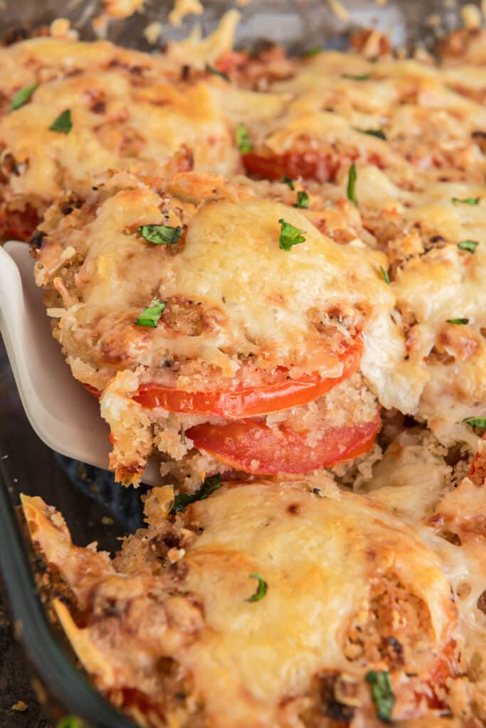 A slice of tomato casserole on a spatula.