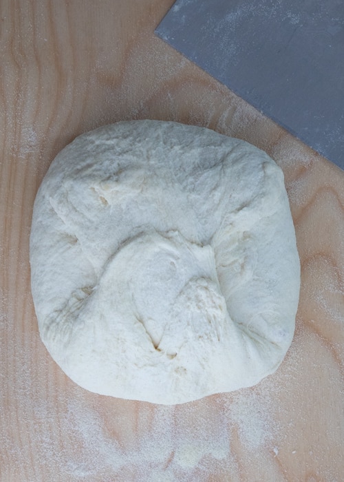 The dough on a wooden board.
