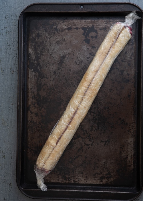 The dough wrapped on a baking sheet.