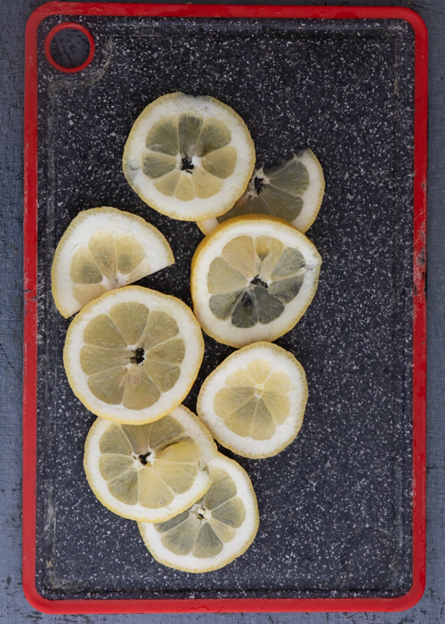 Slicing the lemons on a black board.
