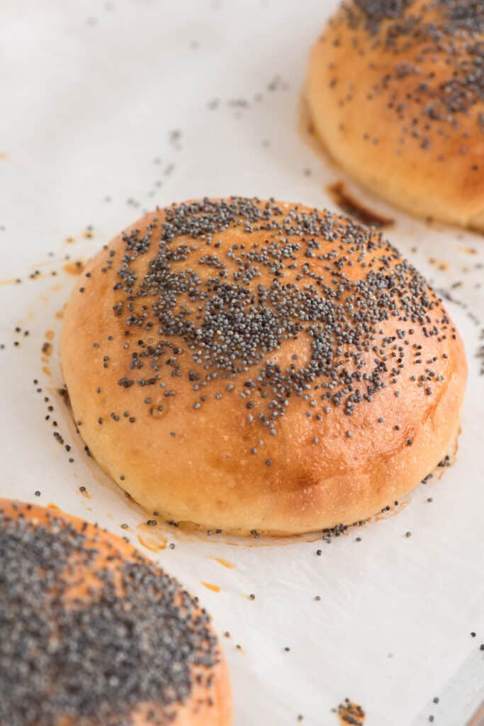 Three milk buns on parchment paper.