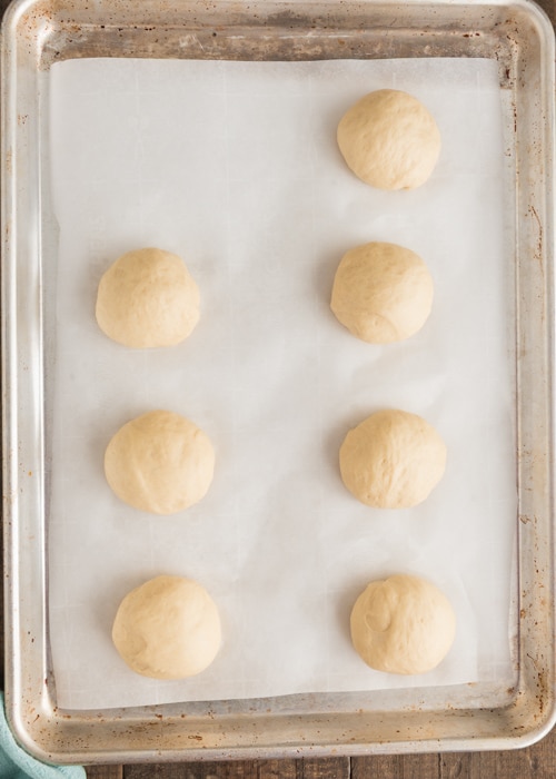 The dough balls on the parchment paper.