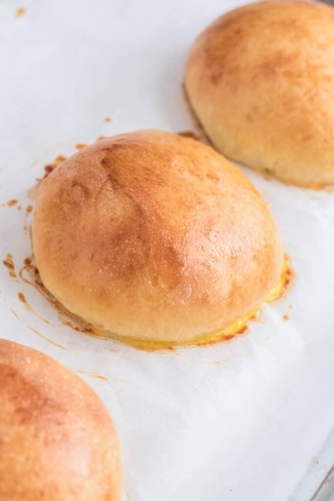 Three buns on a parchment paper.