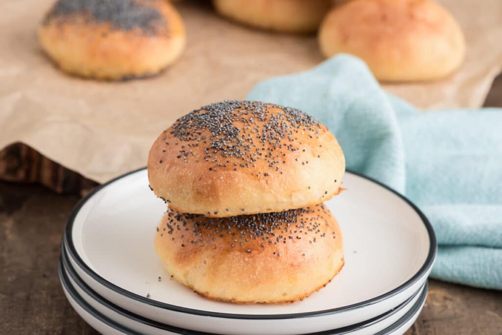 Two buns on the plate stacked.