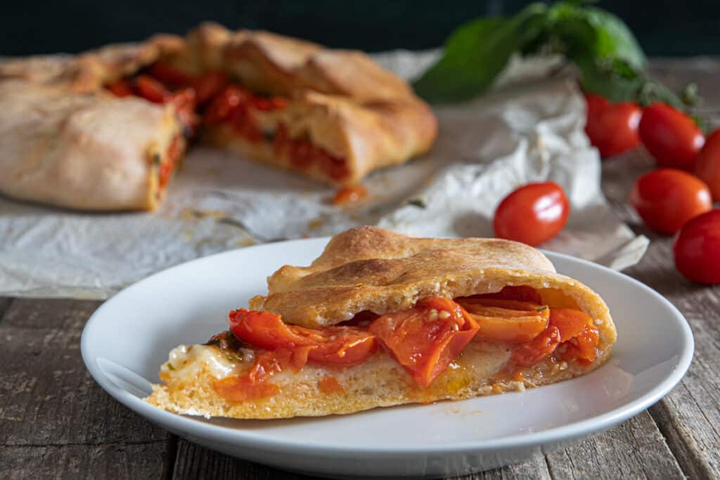 The mustazzedau with a slice cut on a white plate.