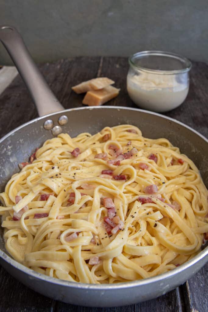 The parmesan pancetta pasta in a silver pan.