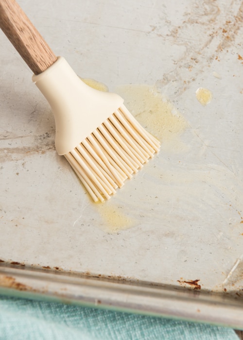 Brushing the pan with a little butter.