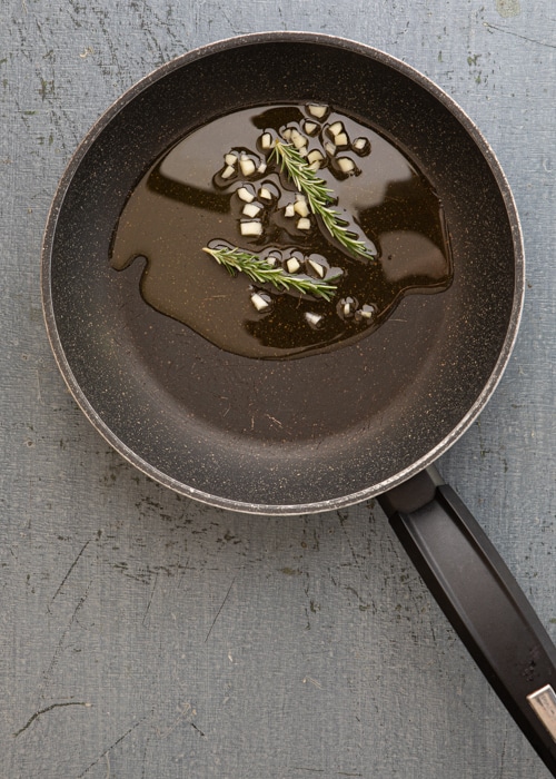 The oil, garlic and spices in the pan.