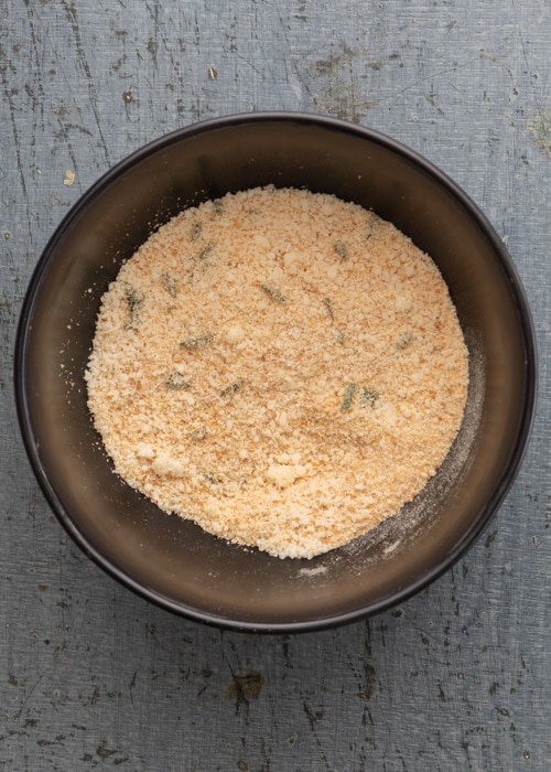The bread crumb mixture made in a black bowl.