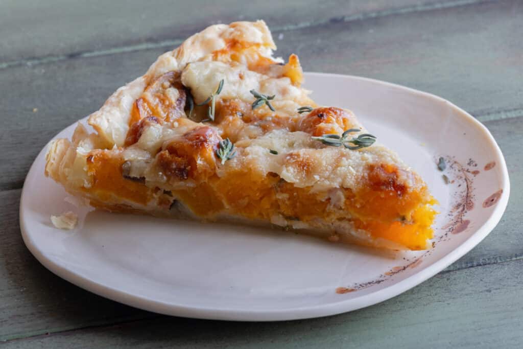 A slice of pie on a white plate.