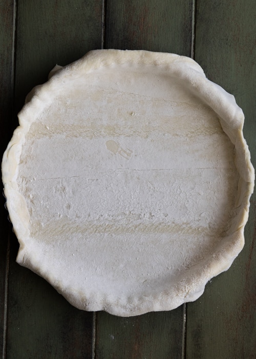 Placing the dough in the pie pan.